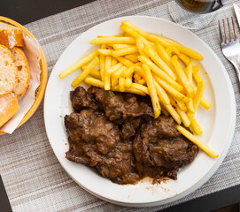 Image of the delicious stewed veal with sauce, served with French fries