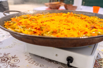 Cooking paella outdoors, a delicious family meal