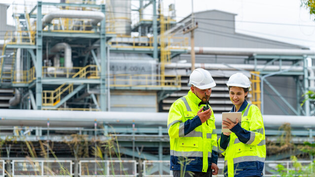 Petrochemical factory industry engineer teamwork meeting discussion at petroleum oil refinery plant. Industrial engineering technician working and maintenance manufacturing energy power gas system.