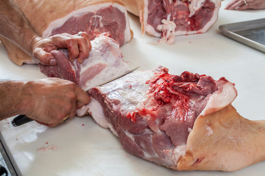 Cutting raw meat on a cutting board