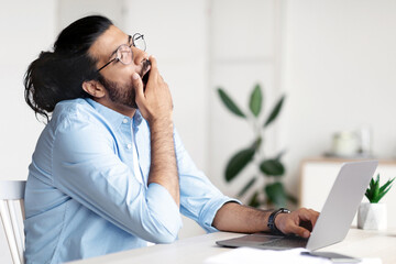 Sleepy Freelancer Guy Yawning At Workplace In Home Office, Tired Of Work With Laptop, Tired Eastern...