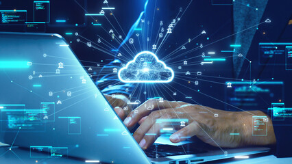 Close-up of hands typing on a laptop with a glowing cloud icon and digital data flow symbols...