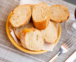 Bread sliced and served on table in wicker plate
