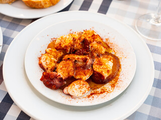 Galician-style octopus, tradicional Spanish dish, served on plate.