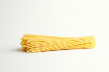 Close-up of uncooked spaghetti arranged neatly, showcasing its long, thin shape and vibrant yellow color.