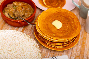 Thick pancakes with slice of butter served with mochanka, thick gravy with meat, mushrooms, vegetables. Popular dish of Belarus cuisine