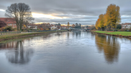 Panoramic View Of River Flowing Through Town In Autumn