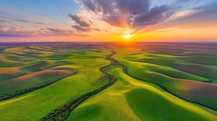 Aerial view of sculpted farmland at sunset.