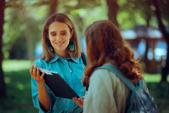 Surveyor Woman Stops people on the Street for an Opinion Poll. Woman with clipboard asks for donations for a noble cause 