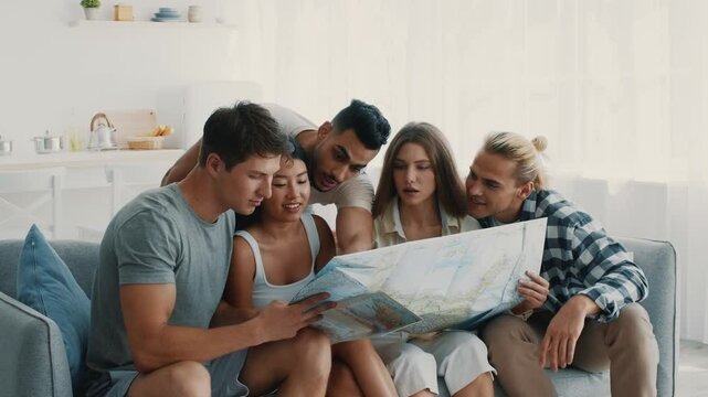 A group of diverse friends gathers in a sunny living room, excitedly discussing their travel plans while studying a large map, sharing laughter and ideas.