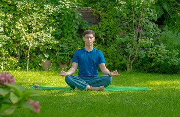 man meditating doing yoga exercises outdoors