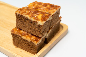 Toffee cake with cashew nuts on wooden tray