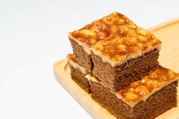 Toffee cake with cashew nuts on wooden tray