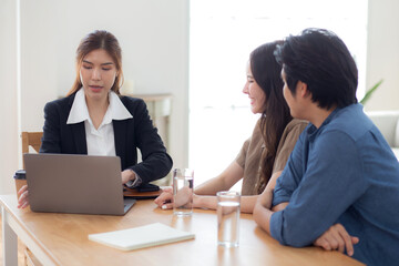 Obraz premium Happy asian couple discussion with real estate agent or insurance agent for investment in home office, mortgage loan or property purchase home, sale explaining insurance plan with couple.