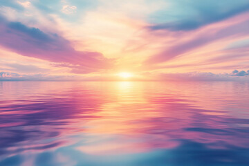 Fototapeta premium A beautiful sunset over the ocean with a pink and purple sky. The water is calm and the sky is filled with clouds