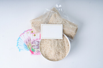 Top View Of Grain Rice And Rupiah Money For Zakat Fitrah With Greeting Card