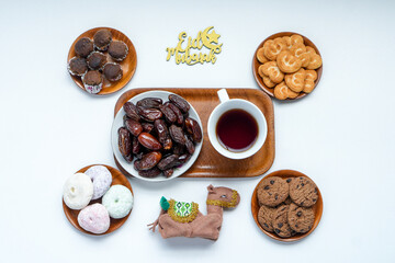 Top View Of Assortment Food With Hot Tea For Eid Mubarak Celebration