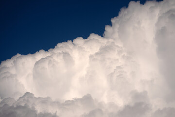 Obraz premium Blue sky with calm clouds background. Bright blue sky background. Cloudscape with white clouds. Calm sky cloudy on a summer day. Sunlight through the clouds wallpaper. Spring sky with soft clouds.