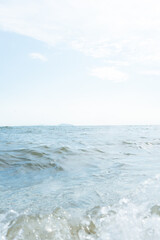Sea waves on the beach against the blue sky with clouds at Bangsan beach in Chonburi, Thailand