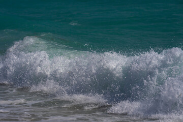 Ocean waves background. Tropical ocean waves. Blue seaside view. Foamy beach coastline. Sandy shore backdrop. Blue sea beach wave.
