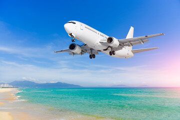 Naklejka premium Airplane jet flies over tropical beach on ocean coast, arrival at resort airport