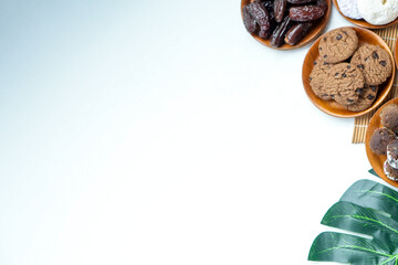 Overhead Shot Of Various Snacks With Dates Fruit And Leaf Decoration On White Background