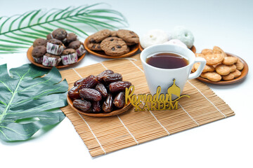 Arrangement Of Dates Fruit, Hot Tea And Various Cookies With Ramadan Kareem Text Decoration