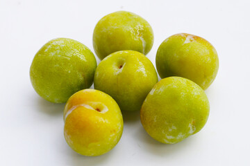 Fresh green plum on white background