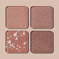 Neutral Eyeshadow Palette with Matte and Shimmer texture, natural colored shades on beige. Set of eyeshadow refills, Top view of four Swatches Eyeshadow makeup for cosmetic, makeup, beauty concept