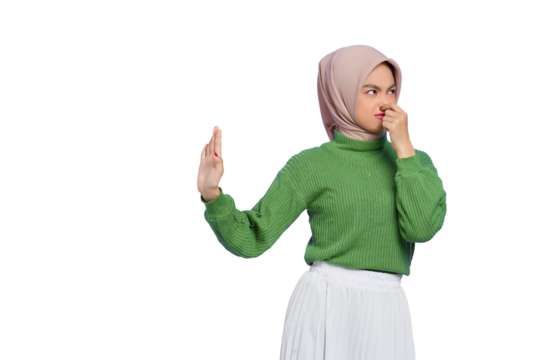 Beautiful annoyed Asian woman in green sweater makes stop gesture, covering her nose with hand isolated on transparent background - Powered by Adobe