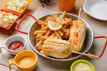 Corn and French Fries with Seasoned Powder on a Silver Plate
