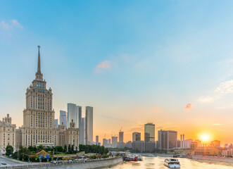 High-rise stalinist building near river at summer sunset in Moscow, Russia. Historic name is Hotel...