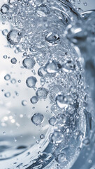 Close-up shot of water with air bubbles. The image shows the beauty and detail of water with a light blue background.