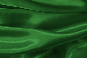 Dark green fabric cloth texture for background and design art work, beautiful crumpled pattern of silk or linen.