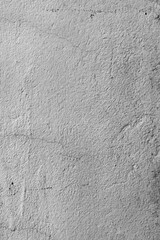 Vertical photo of gray plaster on the wall.