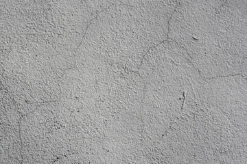 A weathered, time-damaged grey wall.