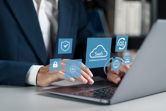 SaaS concept, software as a service. Businessman use laptop with SaaS icons for software services on cloud system. Internet and networking technology.