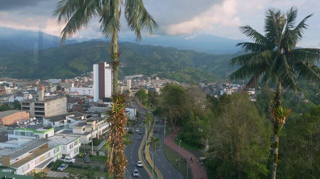 Scenic view of Avenida 12 de Octubre in Manizales, seen from behind the glass of the Chipre Tower, with the city and mountains in the background