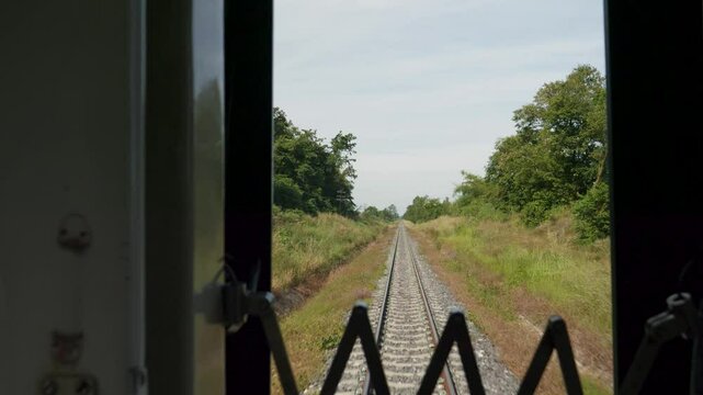 POV shot from train of Thailand's Eastern Line from Bangkok to Ban Klong Luk during the day in Thailand, close up shot