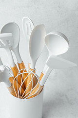 Kitchen utensils in a white container for cooking and baking activities