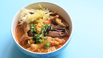 rice vermicelli with northern thai curry sauce on blue background