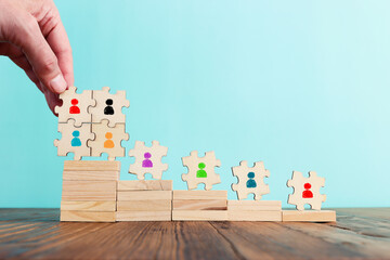 Business image of puzzle with people icons over pastel background, human resources and management concept