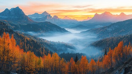 Autumn sunrise over misty mountain valley