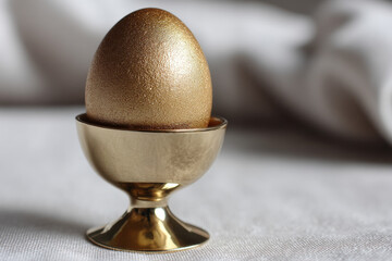 Golden egg in egg cup