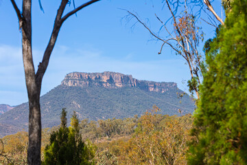 Photograph of a large flat topped cliff faced mountain on a large hill in Capertee Valley in the Central Tablelands of NSW, Australia.