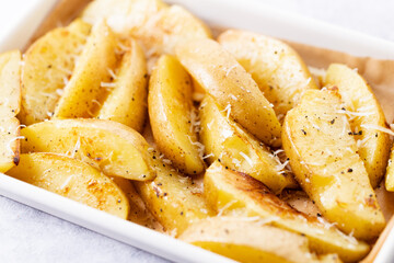 Baked potato wedges with cheese.
