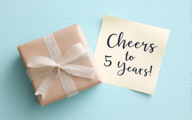happy anniversary celebration with beautifully wrapped gift and note expressing joy for five years of work together