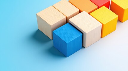 Obraz premium Colorful wooden blocks arranged on blue background creative composition studio environment top view