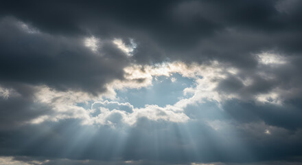 Dramatic sky panorama showcasing sunbeams piercing through layered cloudscape