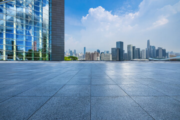 Empty square floor and glass wall with modern city buildings in Shenzhen